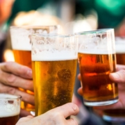 men holding beers in a pub