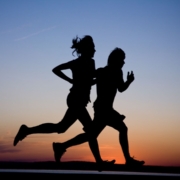 two people running infront of the sunrise