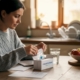 Woman reading food intolerance test instructions at home table