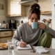 Woman tracking food symptoms in kitchen