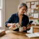 Woman checks food intolerance notes at kitchen