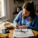 Woman tracking food in a kitchen diary