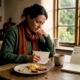 Woman tracking food reactions in kitchen notebook