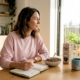 Woman recording food diary in kitchen