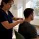 Healthcare worker collecting hair sample from patient