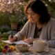 Woman writing food diary in kitchen