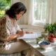 Woman reviewing symptom diary at kitchen table