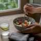 Hands plating small meal in kitchen