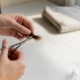 Hands cutting hair sample for intolerance test