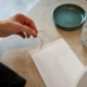 Hand placing hair strands into sample pouch