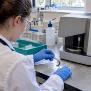 Hair sample beside laboratory analysis equipment