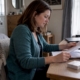 Woman reviewing menopause symptoms at home