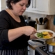 Woman preparing sweetcorn in a home kitchen