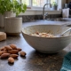 Almonds beside a partly eaten bowl of porridge