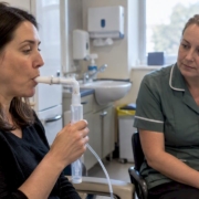 Patient providing a breath sample in clinic