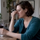 Woman noticing congestion after sipping red wine