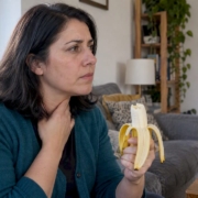Woman pauses after eating a banana