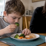 Child carefully exploring unfamiliar food textures