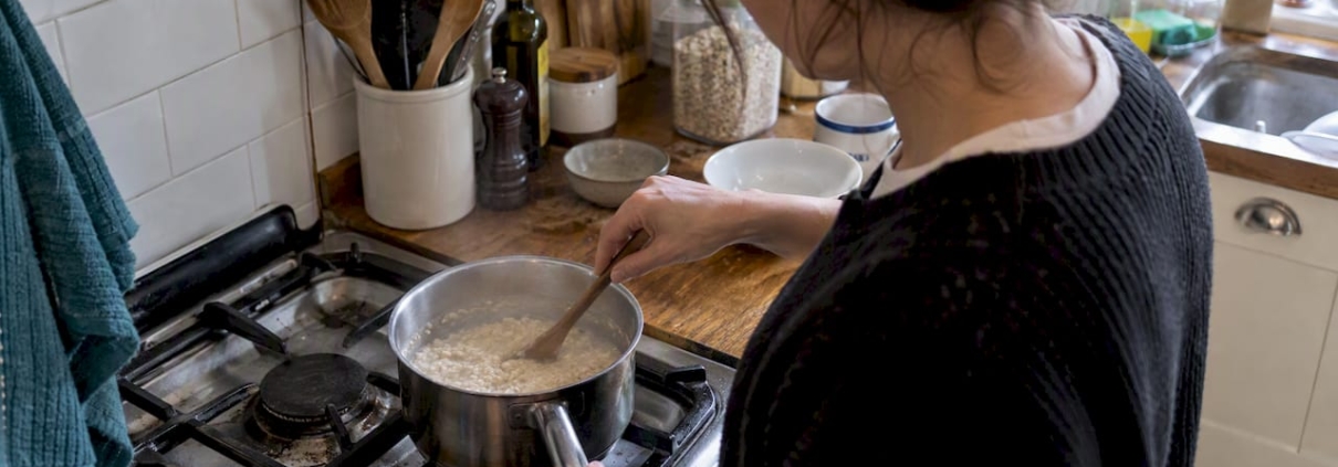 Oats simmering in a saucepan on a hob