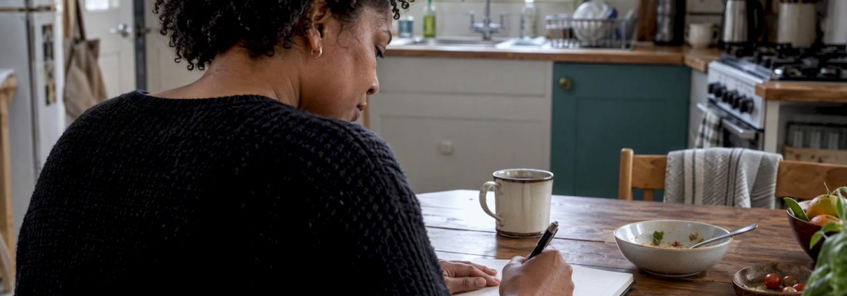 Woman recording a food and symptom diary