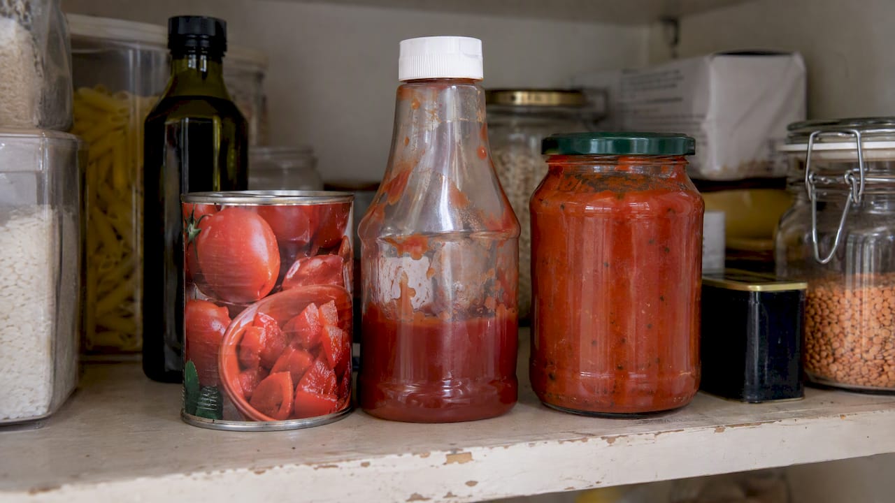 Tinned tomatoes, ketchup and tomato sauce in a pantry