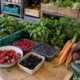 Fresh berries, herbs and vegetables at produce counter